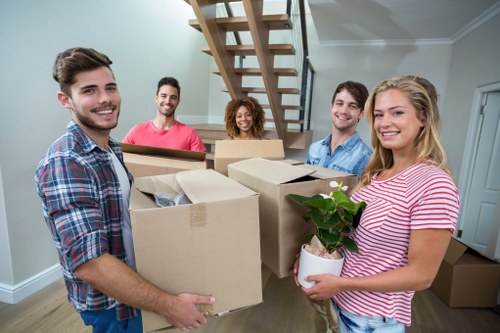 Removal company team loading household items into a vehicle