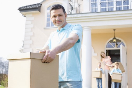 Movers handling boxes and furniture inside an Edgware property