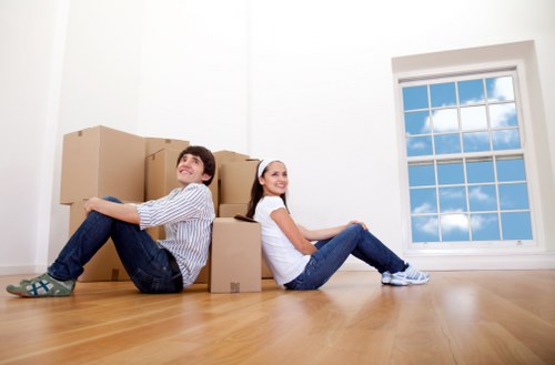 Removal team handling boxes and furniture in Edgware