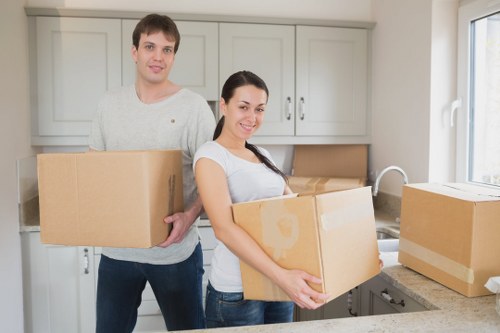 Professional movers handling furniture in an Edgware flat